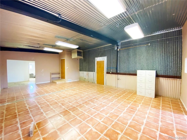 interior space featuring tile patterned flooring and beam ceiling