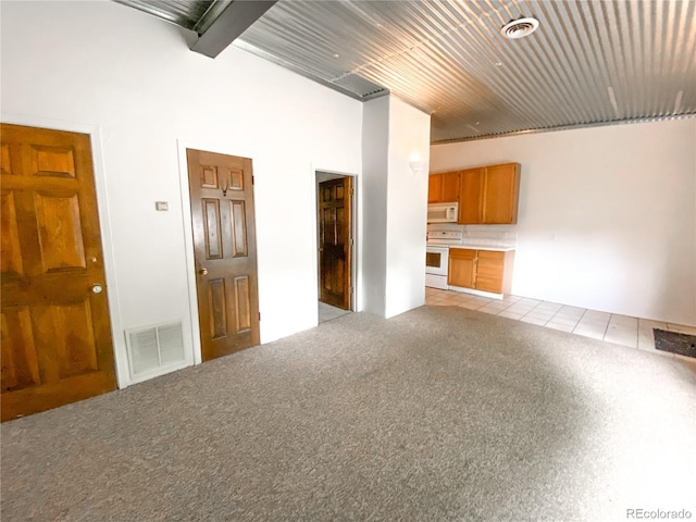 unfurnished living room featuring beamed ceiling, light carpet, and wood ceiling