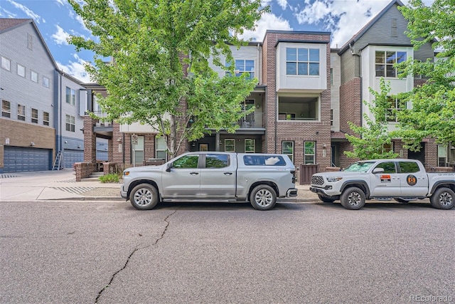 townhome / multi-family property featuring brick siding