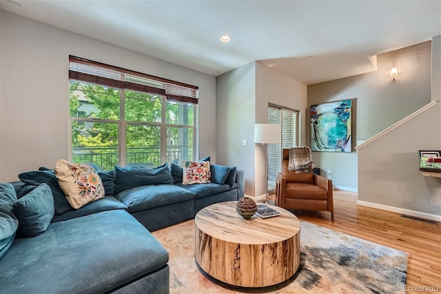 living room with visible vents, recessed lighting, baseboards, and wood finished floors