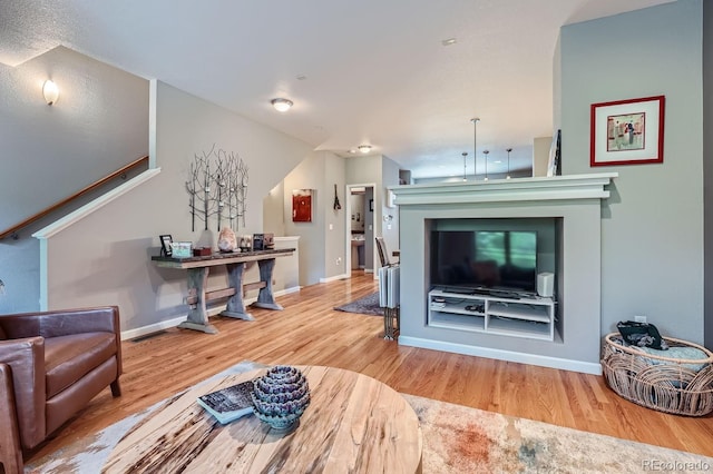 living room with baseboards and wood finished floors