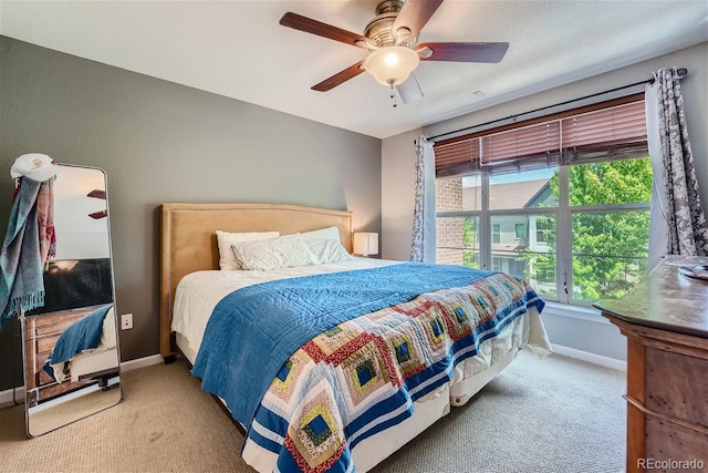 carpeted bedroom featuring a ceiling fan and baseboards