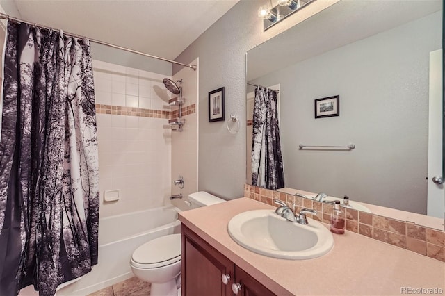 bathroom featuring toilet, shower / tub combo with curtain, vanity, and a textured wall