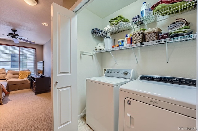 clothes washing area featuring a ceiling fan, laundry area, a textured ceiling, light colored carpet, and independent washer and dryer