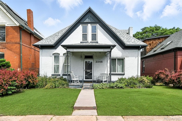 2346 N Gilpin St, Denver, CO 80205 - view of front of property featuring brick siding, a porch, and a front yard