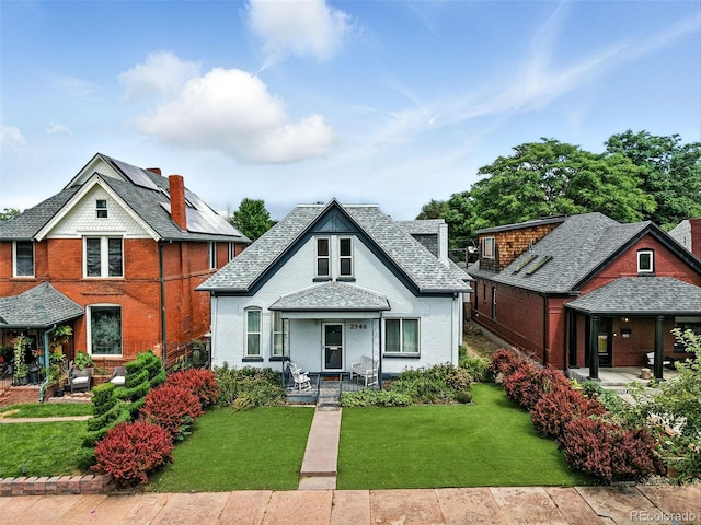 2346 N Gilpin St, Denver, CO 80205 - view of front of home featuring a porch, brick siding, and a front yard