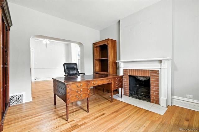 2346 N Gilpin St, Denver, CO 80205 - office space with light wood finished floors, arched walkways, and a brick fireplace