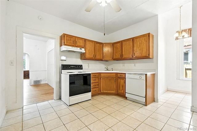 2346 N Gilpin St, Denver, CO 80205 - kitchen with white appliances, light countertops, light tile patterned floors, and brown cabinets