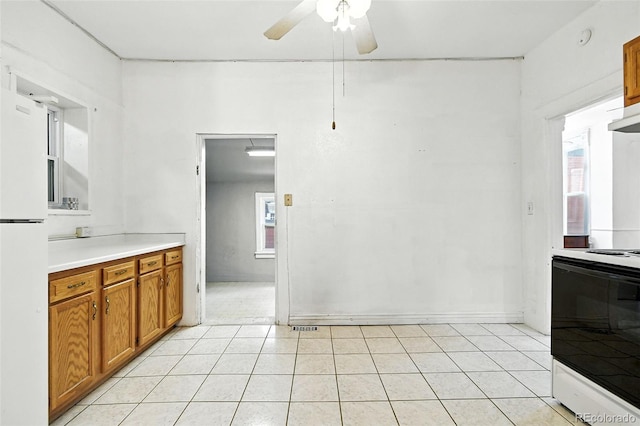 2346 N Gilpin St, Denver, CO 80205 - kitchen with brown cabinetry, white appliances, ceiling fan, light countertops, and light tile patterned floors
