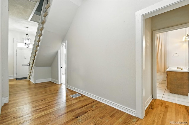 2346 N Gilpin St, Denver, CO 80205 - additional living space featuring light wood-style flooring, a chandelier, and vaulted ceiling