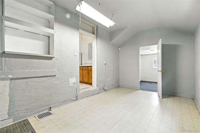 2346 N Gilpin St, Denver, CO 80205 - spare room with lofted ceiling and tile patterned floors