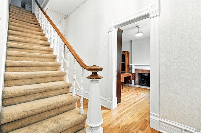 2346 N Gilpin St, Denver, CO 80205 - staircase with wood finished floors and a brick fireplace