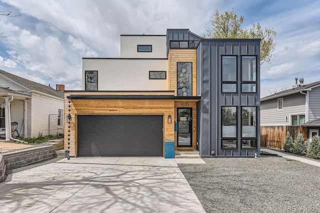 1655 Wolff St, Denver, CO 80204 - contemporary home with board and batten siding, driveway, and a garage