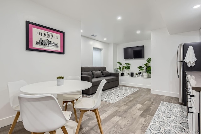 1655 Wolff St, Denver, CO 80204 - dining room featuring light wood-type flooring, baseboards, and recessed lighting