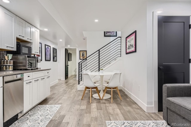 1655 Wolff St, Denver, CO 80204 - kitchen featuring stainless steel dishwasher, light wood-type flooring, white cabinetry, baseboards, and recessed lighting