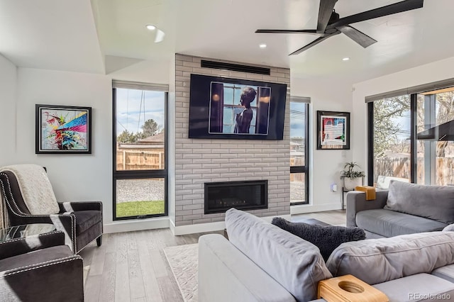 1655 Wolff St, Denver, CO 80204 - living area featuring ceiling fan, healthy amount of natural light, wood finished floors, a brick fireplace, and recessed lighting