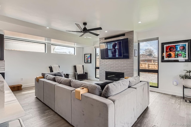 1655 Wolff St, Denver, CO 80204 - living room featuring ceiling fan, wood finished floors, a fireplace, baseboards, and recessed lighting