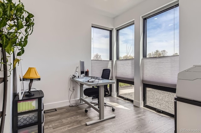 1655 Wolff St, Denver, CO 80204 - office area featuring healthy amount of natural light, wood finished floors, and baseboards