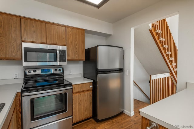 kitchen featuring appliances with stainless steel finishes and light hardwood / wood-style floors