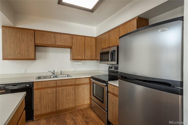 kitchen featuring sink, stainless steel appliances, and dark hardwood / wood-style floors