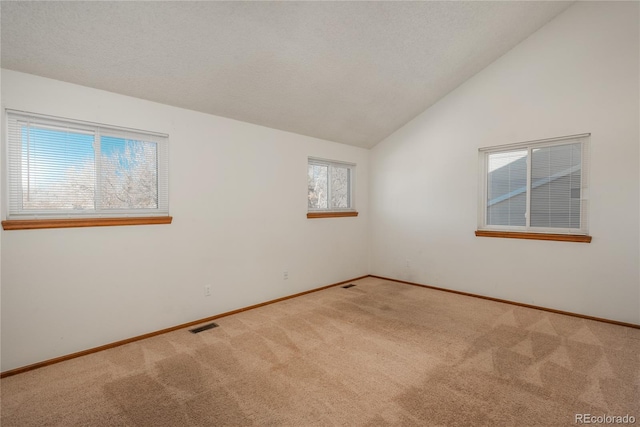 unfurnished room with light carpet and vaulted ceiling