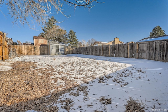 yard layered in snow with an outdoor structure