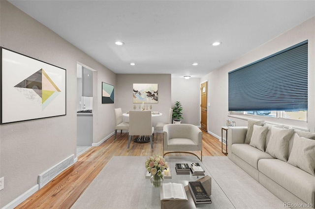 8305 Eaton Way, Arvada, CO 80003 - living room featuring light wood-type flooring, baseboards, and recessed lighting