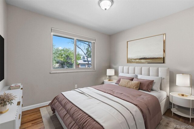 8305 Eaton Way, Arvada, CO 80003 - bedroom featuring wood finished floors and baseboards