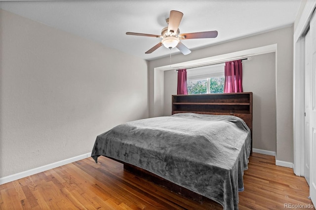 8305 Eaton Way, Arvada, CO 80003 - bedroom featuring baseboards, wood finished floors, a ceiling fan, and a closet