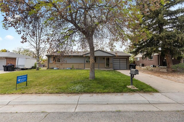 8305 Eaton Way, Arvada, CO 80003 - view of front facade with a garage, driveway, a front lawn, and brick siding