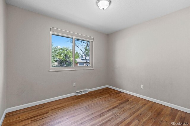 8305 Eaton Way, Arvada, CO 80003 - spare room featuring wood finished floors and baseboards