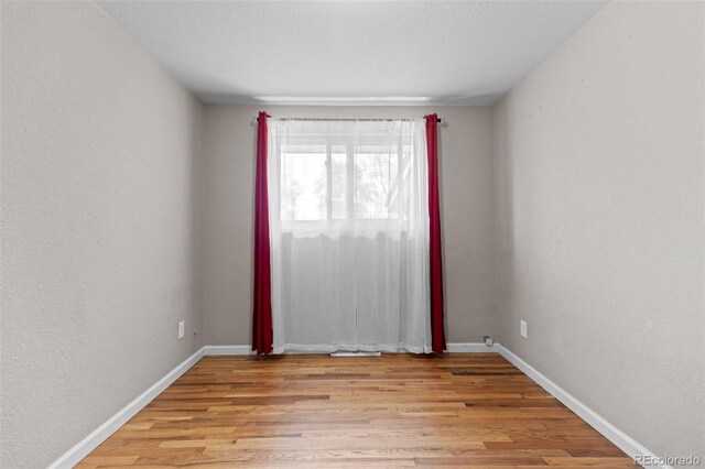 8305 Eaton Way, Arvada, CO 80003 - spare room featuring light wood-style flooring and baseboards