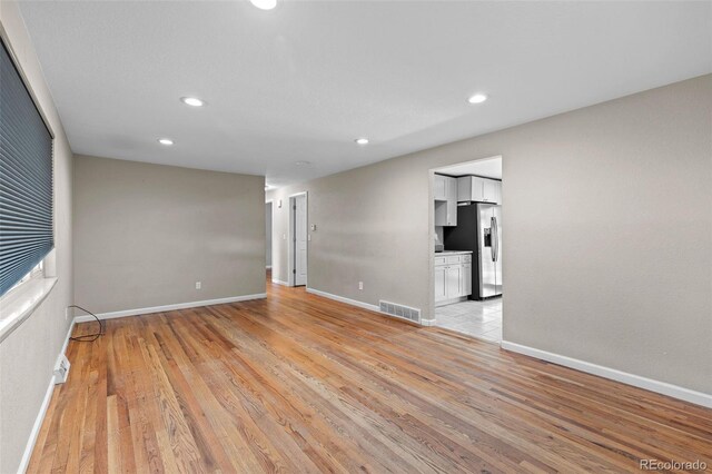8305 Eaton Way, Arvada, CO 80003 - unfurnished room featuring light wood-style floors, baseboards, and recessed lighting
