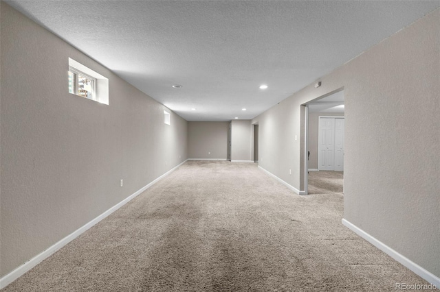 8305 Eaton Way, Arvada, CO 80003 - basement featuring carpet floors, a textured wall, baseboards, a textured ceiling, and recessed lighting