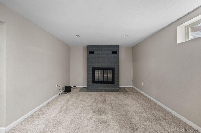 8305 Eaton Way, Arvada, CO 80003 - unfurnished living room featuring a brick fireplace, carpet floors, and baseboards