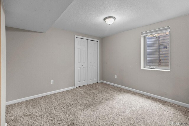 8305 Eaton Way, Arvada, CO 80003 - unfurnished bedroom featuring carpet floors, baseboards, a textured ceiling, and a closet