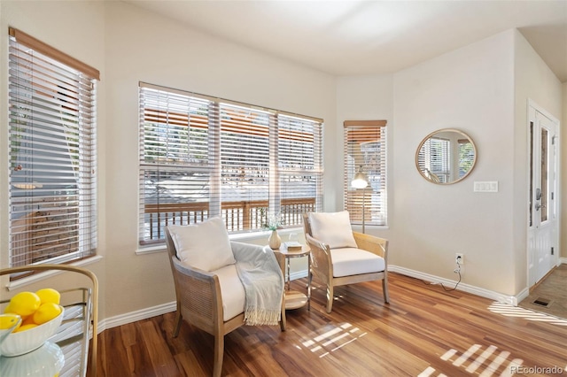 living area featuring a wealth of natural light and light hardwood / wood-style floors