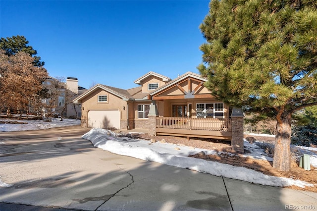 craftsman inspired home with a garage and covered porch