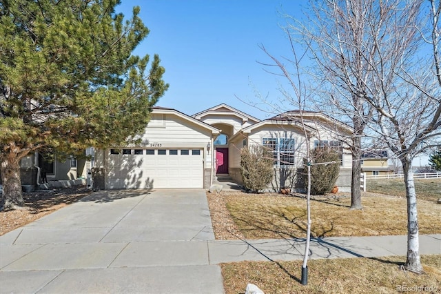 view of front of home featuring concrete driveway and a garage