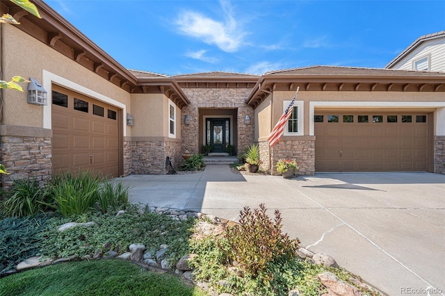 doorway to property with a garage