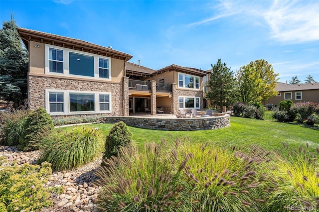 back of house with a patio, a balcony, and a yard