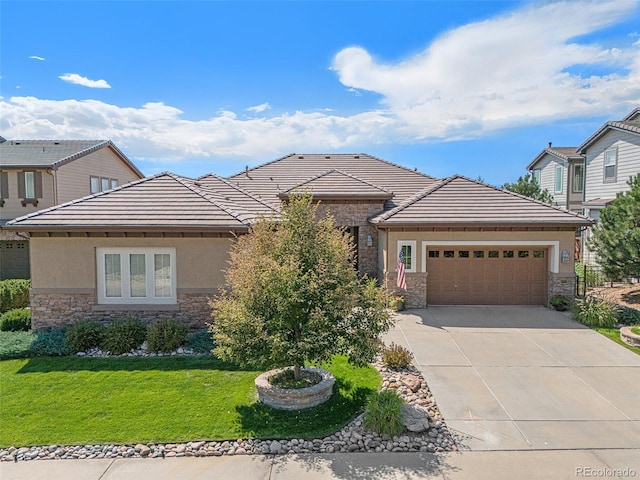 view of front of property featuring a garage and a front yard