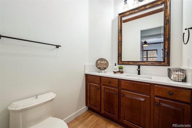 bathroom with vanity, wood-type flooring, and toilet