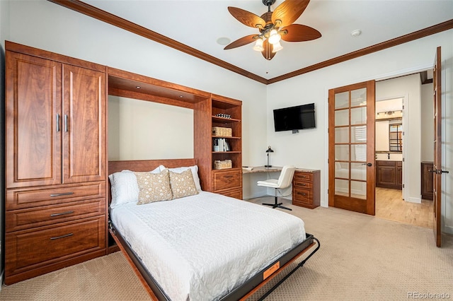 bedroom with ceiling fan, crown molding, light carpet, ensuite bath, and french doors