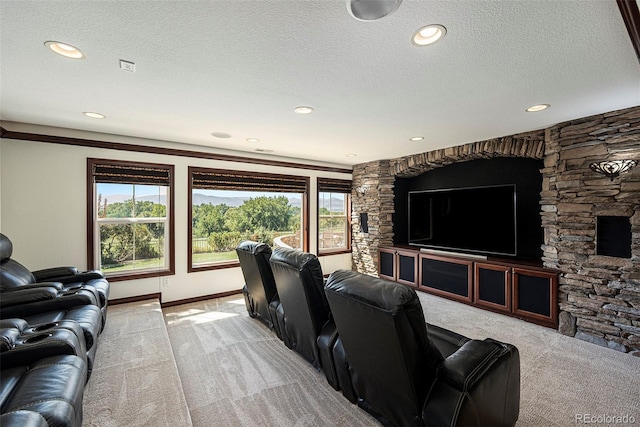 carpeted home theater room featuring a textured ceiling