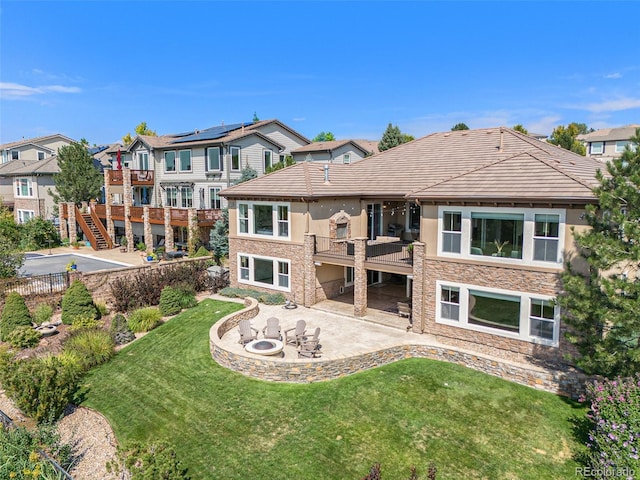 back of property with a yard and a patio area