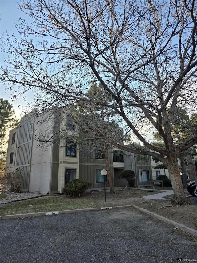 view of building exterior with uncovered parking