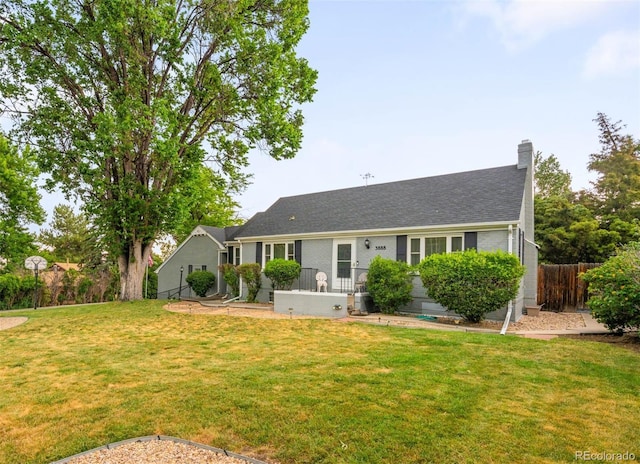 3888 Estes St, Wheat Ridge, CO 80033 - view of front of property featuring a chimney, brick siding, and roof with shingles
