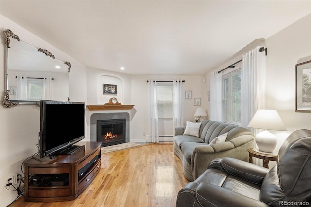 3888 Estes St, Wheat Ridge, CO 80033 - living room with light wood-type flooring, a tile fireplace, baseboard heating, and recessed lighting