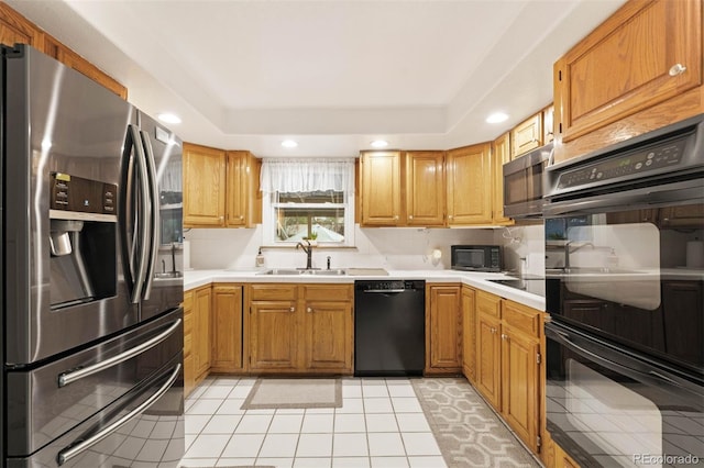 3888 Estes St, Wheat Ridge, CO 80033 - kitchen featuring black appliances, recessed lighting, light countertops, and a tray ceiling
